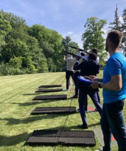 En gruppe mennesker står på række med laser riffel klar til at skyde efter lerduer. Få en sikker og sjov skydeoplevelse: ren action og sjov! Perfekt til events. Laser lerdueskydning er ideelt til teambuilding, hvor alle kan være med og bidrage til holdets succes.